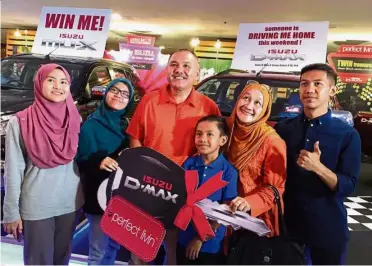  ??  ?? Reason to smile: Normah (second from right) basking in her victory with (from left) daughters Nur Syazwani Muhammad and Nur Diyana Muhammad, husband Muhammad Abdullah, son Amirul Hisyam Muhammad and nephew Safwan Abdul Ghafar.