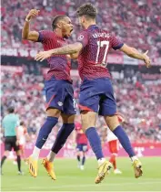  ?? ?? Leipzig's Dominik Szoboszlai (L) and Christophe­r Nkunku celebrate after their third goal (AFP)