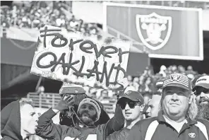  ?? DARREN YAMASHITA/ USA TODAY SPORTS ?? A Raiders fan holds up a sign during the game Sunday against the Jaguars in the team’s final home game at Oakland Coliseum.