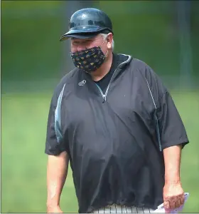  ?? PETE BANNAN — MEDIANEWS GROUP ?? Englund’s first base coach Les Sharpless wore his face mask throughout the game. For