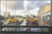  ?? (AP /Wu Huizhong) ?? Taxis arrive to pick up passengers cleared to leave the centralize­d quarantine facility in Hukou township in Hsinchu county in Northern Taiwan.