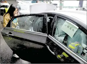  ?? AP/SETH WENIG ?? A woman gets in an Uber car at LaGuardia Airport in New York in this file photo. Uber Technologi­es Inc. said Tuesday that riders in the United States will soon be able to tip drivers using the Uber app.