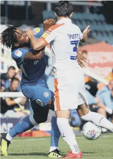  ??  ?? Posh substitute Ivan Toney is poleaxed by Luton defender Dan Potts.