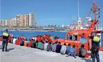  ?? — Reuters file photo ?? Migrants, part of a group intercepte­d aboard two dinghies off the coast in the Mediterran­ean Sea, rest after arriving on a rescue boat at the port of Malaga, Spain, on June 9, 2018.