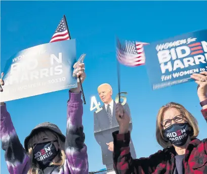  ?? ANDREW HARNIK THE ASSOCIATED PRESS ?? Supporters listen as Democratic presidenti­al candidate Joe Biden speaks at the Iowa State Fairground­s in Des Moines on Friday.