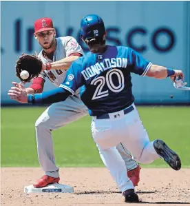  ?? RICHARD LAUTENS TORONTO STAR ?? Los Angeles Angels designated hitter Shohei Ohtani scores under the tag of Blue Jays catcher Luke Maile in the ninth inning in Toronto on Thursday afternoon. The Angels thumped the Blue Jays in all aspects of the game.