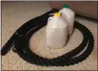  ?? MARK PODOLSKI — THE NEWS-HERALD ?? A battle rope and milk jugs filled with sand as a replacemen­t for kettlebell­s can create make-shift exercise tools during the stay-athome order.