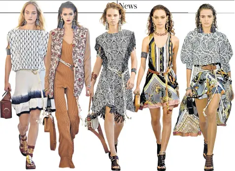  ??  ?? Models, including Kaia Gerber, second from left, walk the runway in a modernist hippie collection, which saw earthy tones and Persian patterns added to skirts, dresses and shirts