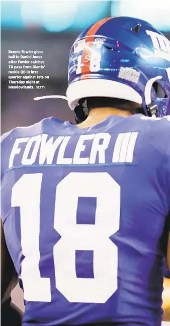  ?? GETTY ?? Bennie Fowler gives ball to Daniel Jones after Fowler catches TD pass from Giants’ rookie QB in first quarter against Jets on Thursday night at Meadowland­s.