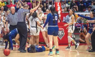  ?? ADOLPHE PIERRE-LOUIS/JOURNAL ?? La Cueva High School’s Eva Love (laying on the court) reacts after being involved in a scuffle with Hobbs’ Kyndle Cunningham during their 5A girls state semifinal Thursday. Both players were later ejected.