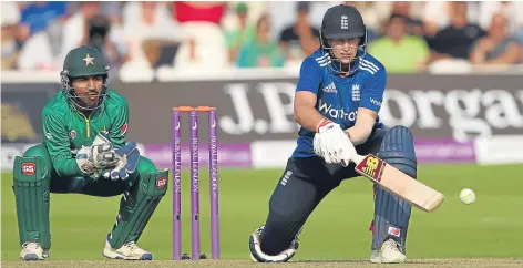  ??  ?? Joe Root reverse sweeps as Pakistan wicket keeper Sarfraz Ahmed looks on at Lord’s yesterday.