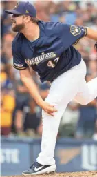  ?? COLIN BOYLE /MILWAUKEE JOURNAL SENTINEL ?? Brewers relief pitcher Matt Albers pitches out of a bases-loaded jam in the ninth inning to pick up the save against the Twins on Wednesday afternoon.