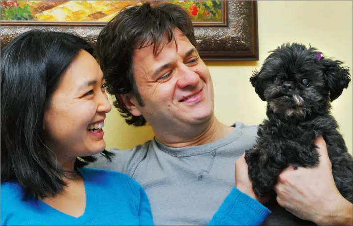  ?? Bruce Edwards, The Journal ?? Amy Wong and Eric Tremblay with their beloved dog, Molly. Not only is Molly the city’s most popular breed of dog, a Shih Tzu, but her name is the third-most popular among licensed dogs.