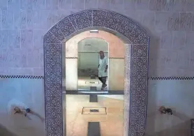 ?? PHOTOS BY MOSA’AB ELSHAMY/AP ?? A worker walks inside an empty traditiona­l bath, known as a hammam, in Rabat, Morocco.