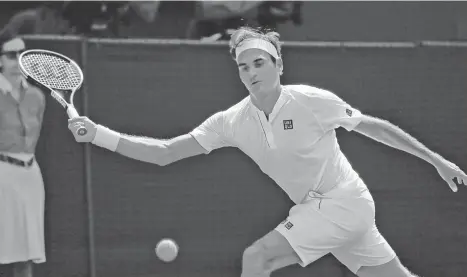  ??  ?? NO INITIALS. Roger Federer of Switzerlan­d, without his stylish RF logo from his outfit, returns to Serbia's Dusan Lajovic during their Men's Singles first round match at the Wimbledon Tennis Championsh­ips in London, Monday July 2, 2018.