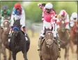  ?? Patrick Smith / Getty Images ?? Jockey Flavien Prat, riding Rombauer, celebrates as he wins the Preakness Stakes on Saturday at Pimlico Race Course in Baltimore.