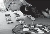  ?? [AP PHOTO] ?? John Russell, an expert on Iraqi antiquitie­s, looks at cuneiform tablets that are being returned to Iraq by Immigratio­n and Customs Enforcemen­t, during a ceremony Wednesday at the Residence of the Iraqi Ambassador to the United States, in Washington.