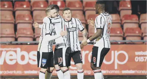  ??  ?? 0 Dunfermlin­e’s Andy Ryan, left, celebrates his goal with team-mates during last night’s 1-1 draw with Morton at East End Park.