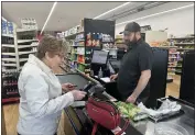  ?? ?? Brian Horak rings up Corliss Hassler at Post 60Market in Emerson, Neb. Hassler is a regular customer and investor in the cooperativ­e grocery store, which opened in 2022.