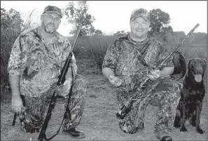  ?? Arkansas Democrat-Gazette/BRYAN HENDRICKS ?? Pete Hornibrook of Little Rock (left) and Alan Thomas of Russellvil­le enjoy the last minutes of a successful dove hunt last Saturday on the banks of the Arkansas River.
