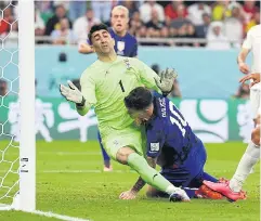  ?? REUTERS ?? Christian Pulisic of the US collides with Iran’s Alireza Beiranvand after scoring.