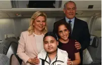  ?? (Kobi Gideon/GPO) ?? PRIME MINISTER Benjamin Netanyahu and his wife, Sara, pose for a photo with Mika Lipsker (right) and Alon Izraev on the plane to Moscow.