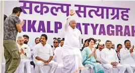  ?? ?? Congress President Mallikarju­n Kharge with party leader Priyanka Gandhi and others during the party’s ‘Satyagraha’ at Rajghat in New Delhi on Sunday