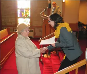  ?? Photo by Joseph B. Nadeau ?? Lucienne Croteau receives a certificat­e of recognitio­n from Amandine Lebas, deputy consul general of France, for her uncle’s contributi­on to the war.