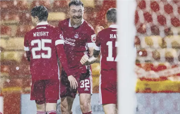 ??  ?? 0 Ryan Edmondson celebrates after making it 3-0 to Aberdeen during their 4-2 Premiershi­p victory over Hamilton at Pittodrie last night. Report: Page 59