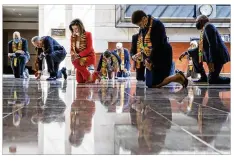  ??  ?? House Speaker Nancy Pelosi and other members of Congress kneel Monday at the Capitol’s Emancipati­on Hall, reading names of George Floyd and others killed in police interactio­ns.