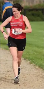  ??  ?? Yasmin Canning checks her watch on her way to finishing at the Ratoath Half Marathon.