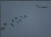  ?? LEO CORREA — THE ASSOCIATED PRESS ?? An aircraft airdrops humanitari­an aid over the northern Gaza Strip as seen from southern Israel on Thursday.