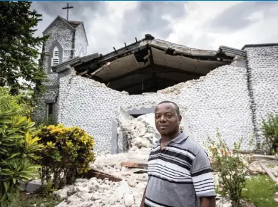  ?? JOSE A. IGLESIAS jiglesias@elnuevoher­ald.com ?? Father Corneille Fortuna stands in front of the destroyed church at a school campus in Camp Perrin near Les Cayes. Fortuna was among those who were trapped by fallen debris during the Aug. 14 earthquake in southweste­rn Haiti.