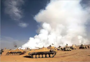  ?? PICTURE: REUTERS ?? Iraqi tanks and armoured vehicles pause after the liberation of a village from Islamic State militants, south of Mosul.