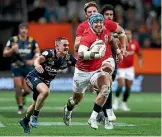  ?? PHOTO: GETTY IMAGES ?? Feilding halfback Kayne Hammington, left, chases down Lions wing Jack Nowell.