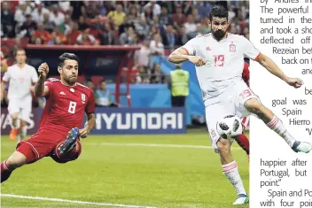  ?? AP ?? Iran’s Morteza Pouraligan­ji tries to block Diego Costa’s (right) shot during their Group B FIFA World Cup match at the Kazan Arena in Kazan, Russia, yesterday.