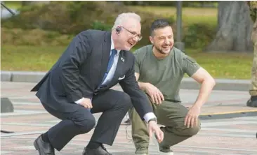  ?? EFREM LUKATSKY/AP ?? Ukrainian President Volodymyr Zelenskyy, right, and Latvian President Egils Levits smile Friday at the Walk of the Brave in Kyiv. The Walk of the Brave honors those who have helped in the struggle against Russia’s invasion of Ukraine.