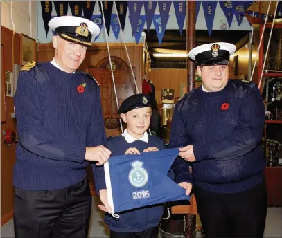  ??  ?? BACk To BASe: Captain of the Sea Cadets Phil Russell RN visited Ruislip Sea Cadet headquarte­rs in Cordingley Road, now open again after major repairs – here he presents a burgee to PO Ian Harris, officer-in-charge of Ruislip Unit and to Junior Cadet...