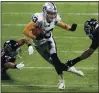  ?? DANNY KARNIK — THE ASSOCIATED PRESS ?? Raiders wide receiver Hunter Renfrow works against Falcons defenders Kendall Sheffield, left, and Charles Harris on Sunday.