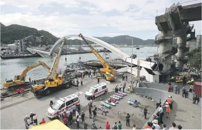  ?? Picture: EPA-EFE ?? DISASTER STRIKES. Rescuers inspect the collapsed Nanfangao Bridge in Yilan County in Taiwan yesterday. The bridge collapsed soon after an oil tanker went onto it. The tanker fell in the water and ignited.