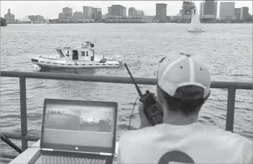  ?? Steven Senne Associated Press ?? COMPUTER SCIENTIST Mohamed Saad Ibn Seddik uses a laptop last month to guide a boat outfitted with sensors and self-navigating software and capable of autonomous navigation in Boston Harbor.