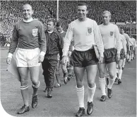  ??  ?? Jimmy Armfield leads out England to face a Rest of the World XI, led by Alfredo di Stefano, at Wembley in celebratio­n of the FA’s Centenary in 1963