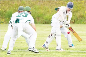  ??  ?? Jindivick’s Jack Braddick looks to turn the ball on the leg side past the Garfield-Tynong fielders who put on the pressure.