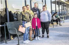  ?? PEDRO PORTAL pportal@miamiheral­d.com ?? Areimy Montilla, second from left, poses with her Cuban migrant family who recently arrived, from left: Yulian Musderien, Ana Laura Montilla, Joseliel Montilla and Tatiana Valdez Roque, as they line up outside of the Hialeah’s Department of Children and Family offices located at 3805 W 20th Ave. on Feb. 14. The family was looking to receive some benefits after entering the U.S. through the Mexican border amid an influx of migrants coming to Miami-Dade County.