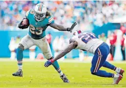  ?? AL DIAZ/TNS ?? Dolphins running back Jay Ajayi (23) broke the 200-yards-rushing mark against the Bills on Oct. 23 at Hard Rock Stadium in Miami Gardens.