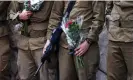  ?? Ronaldo Schemidt/AFP/Getty Images ?? Comrades of French-Israeli soldier Eli Valentin Ghenassia during his funeral in the Mount Herzl cemetery in Jerusalem. Photograph: