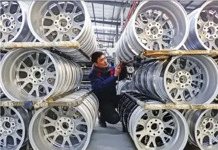  ?? STR/AFP/GeTTy ImAGeS ?? A worker checks wheels at a factory in Lianyungan­g, China last month. As automation curbs the hunt for cheap labour, manufactur­ers locate closer to their customers, which means Canada’s best trade opportunit­ies may be found closer to home, according to researcher­s at the McKinsey Global Institute.