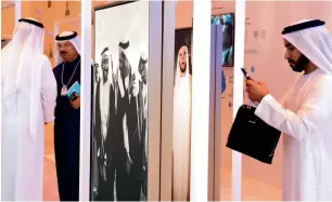  ?? Photos by Shihab, Dhes Handumon ?? A visitor takes photograph­s of an exhibition about Sheikh Zayed. —