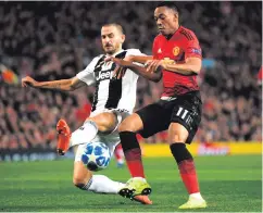  ??  ?? Strong challenge: Anthony Martial tackled by Leonardo Bonucci
