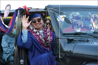  ?? RECORDER PHOTO BY NAYIRAH DOSU ?? Strathmore High School’s Aaron Estrada waves from a decorated vehicle during the commenceme­nt ceremony, Thursday, May 28, 2020, at Spartan Stadium.